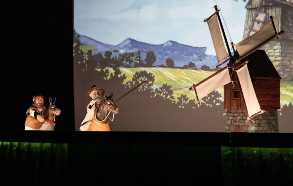 Puppets of Don Quixote and Sancho Panza in front of a windmill